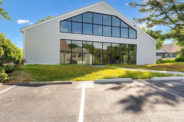 back of property featuring uncovered parking