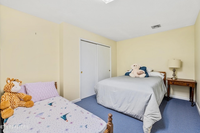 bedroom featuring a closet and dark colored carpet