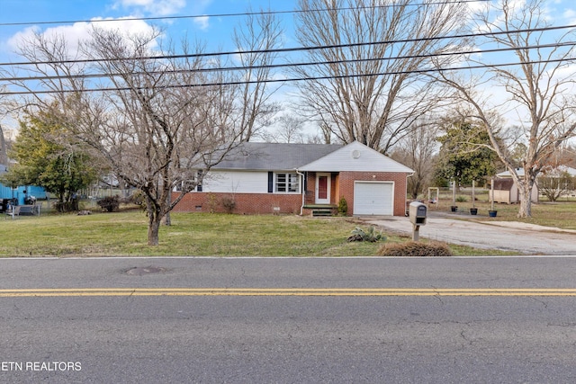 view of front of property featuring driveway, an attached garage, a front lawn, and brick siding