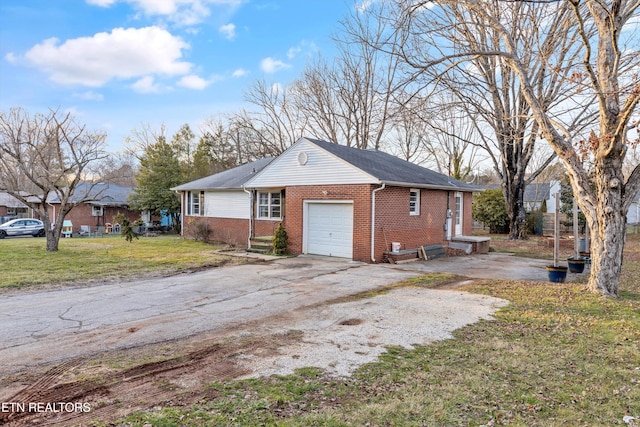 view of front of house with a front lawn, brick siding, driveway, and an attached garage