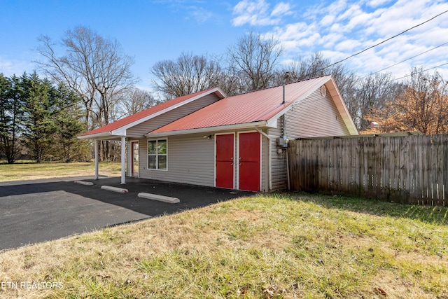 view of side of property with a yard