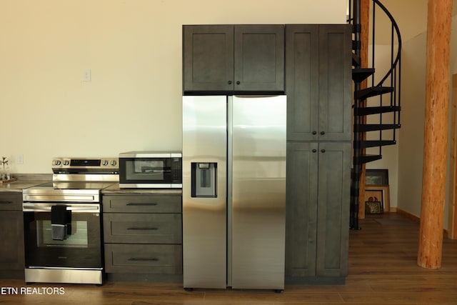 kitchen featuring appliances with stainless steel finishes and dark hardwood / wood-style flooring