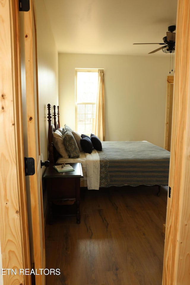 bedroom featuring ceiling fan and dark hardwood / wood-style floors