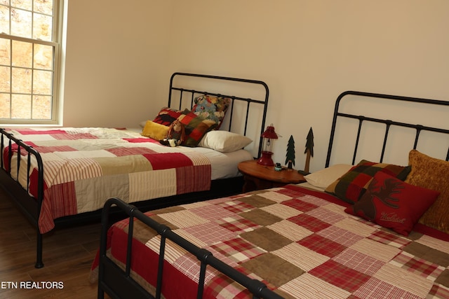 bedroom with dark wood-type flooring