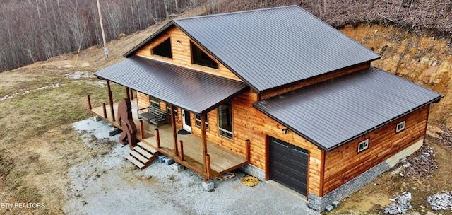 exterior space with a porch and a garage