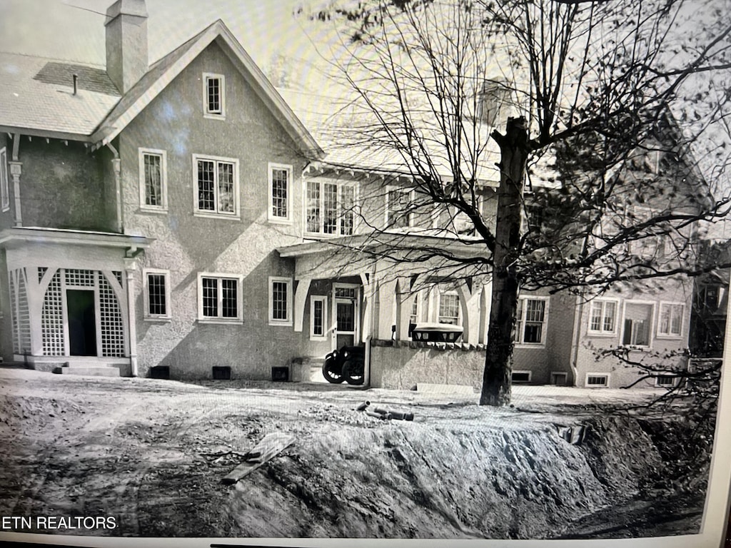 view of snow covered back of property