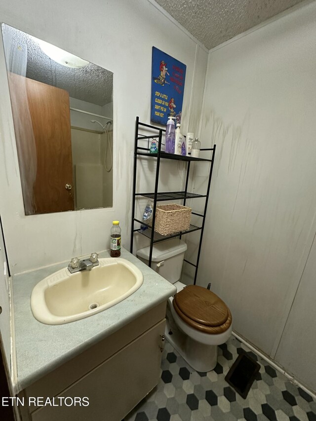 full bath with a shower, toilet, tile patterned floors, a textured ceiling, and vanity