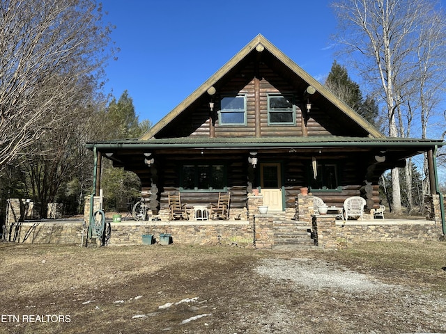 log cabin with a porch