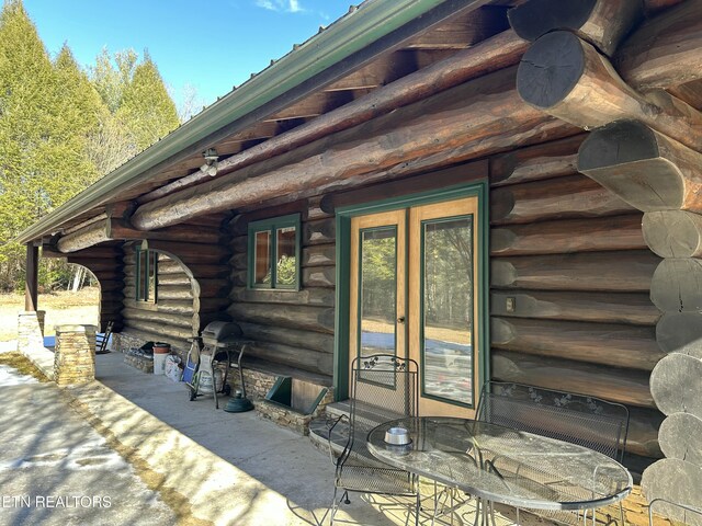 entrance to property with a patio and log exterior