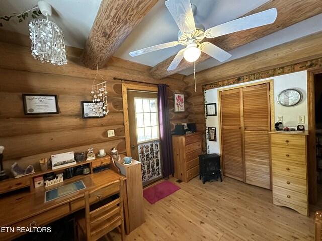 office space with a ceiling fan, light wood-type flooring, and beam ceiling