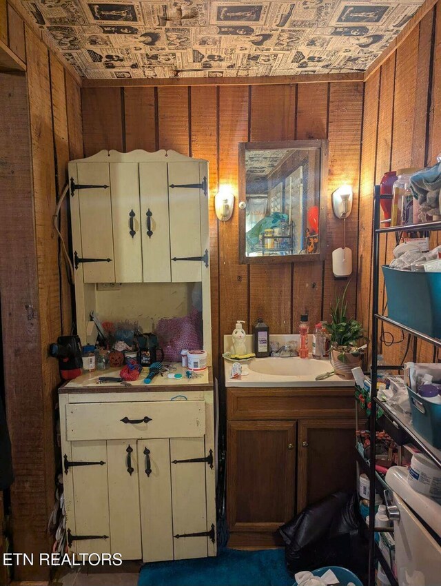 bathroom with wood walls and vanity