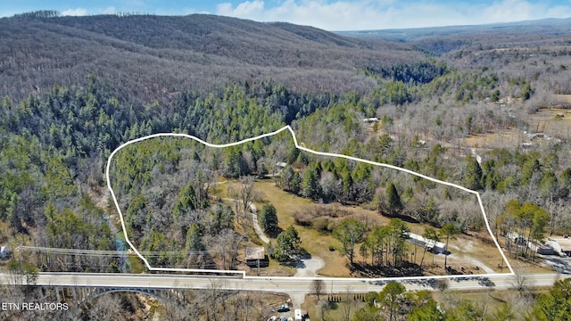 aerial view with a mountain view and a forest view