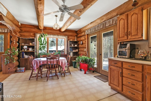 dining area with a ceiling fan, french doors, beamed ceiling, and light floors