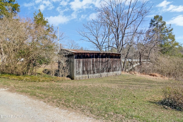 view of pole building with a yard