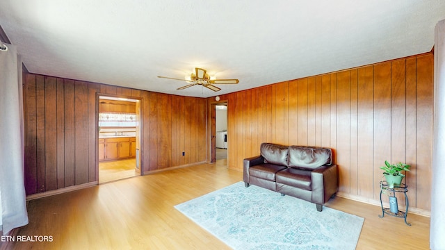 living area featuring ceiling fan and light hardwood / wood-style floors