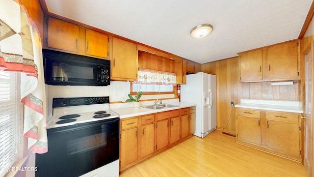 kitchen featuring range with electric cooktop, light wood-type flooring, sink, and white fridge with ice dispenser