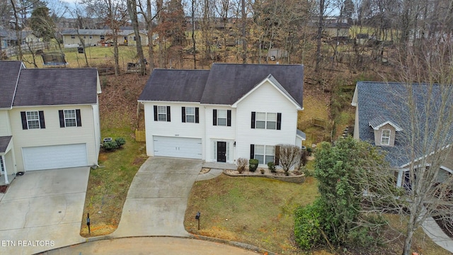 view of front of house featuring a garage and a front lawn