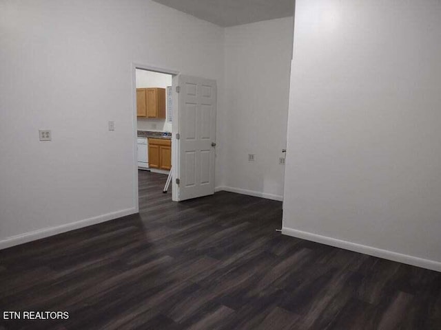 spare room with dark hardwood / wood-style flooring