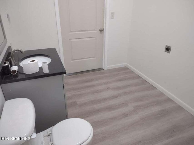 bathroom with vanity, wood-type flooring, and toilet