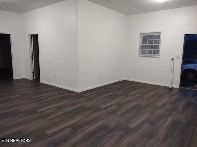 empty room featuring dark wood-type flooring