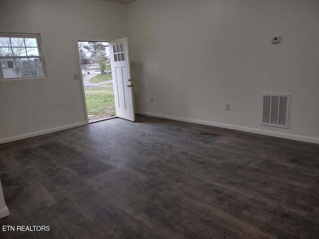 spare room with dark hardwood / wood-style floors