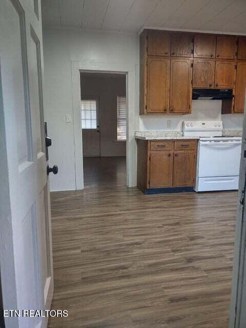 kitchen with dark hardwood / wood-style floors and white range with electric stovetop