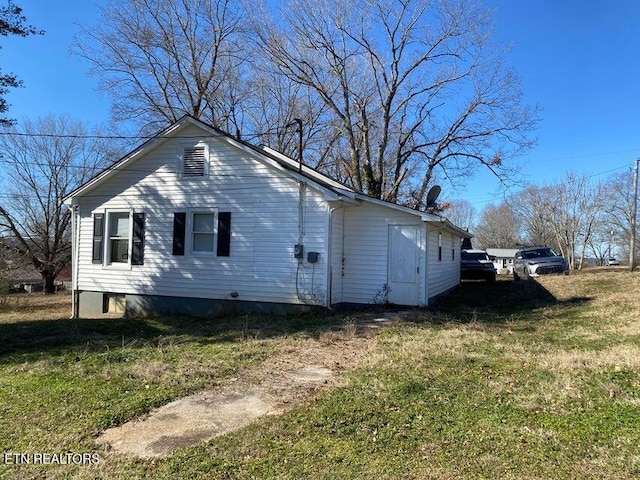 view of home's exterior with a yard