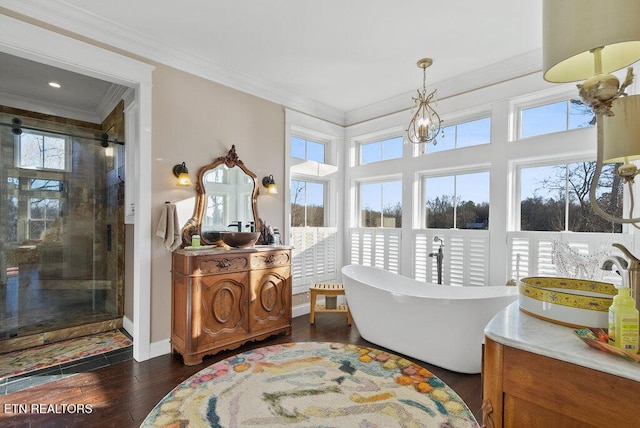 living area featuring ornamental molding, a chandelier, baseboards, and dark wood-style floors