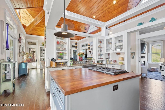 kitchen featuring wooden ceiling, butcher block counters, glass insert cabinets, and white cabinetry