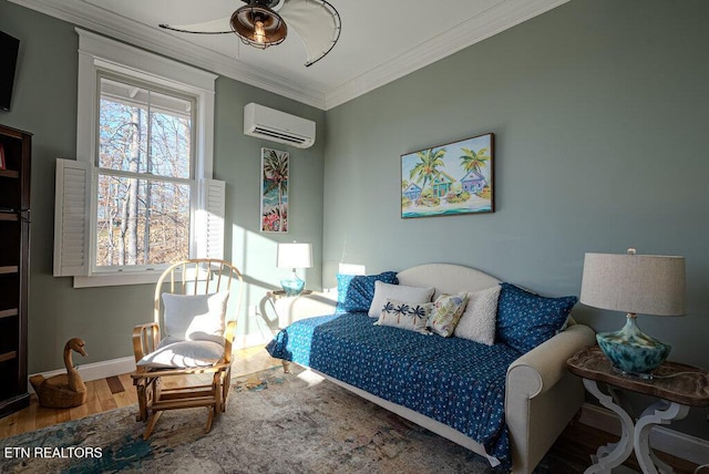 bedroom with baseboards, an AC wall unit, wood finished floors, and crown molding