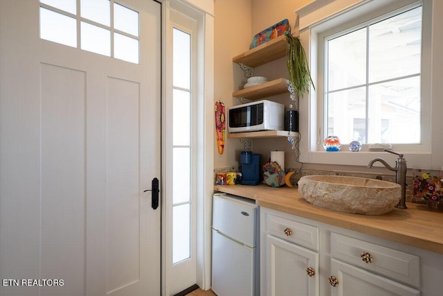 doorway to outside featuring a sink