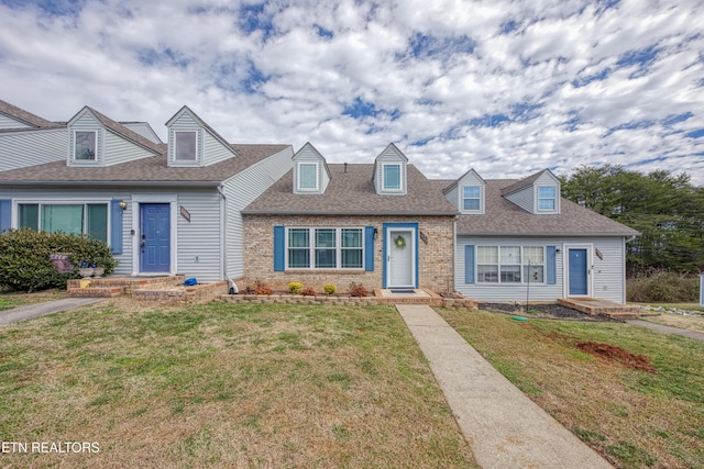 cape cod home with a front yard