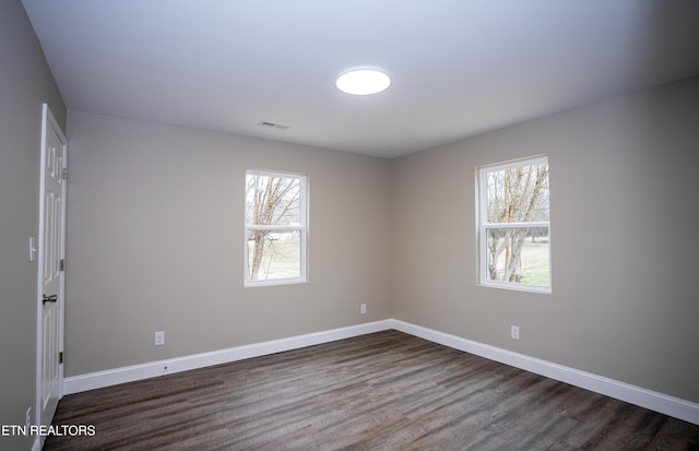 empty room featuring dark wood-type flooring