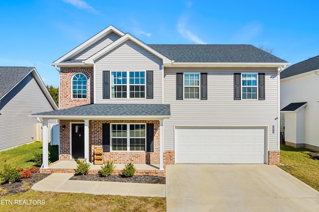 view of front of property with a porch and a garage