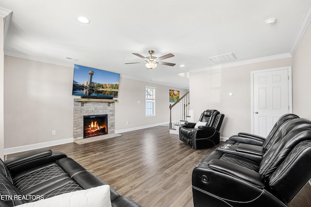 living room with ornamental molding, hardwood / wood-style flooring, and ceiling fan