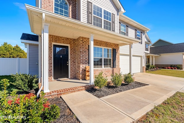 entrance to property featuring a garage and a porch