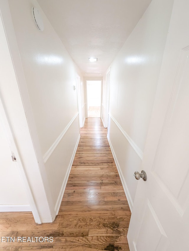 hall with wood-type flooring