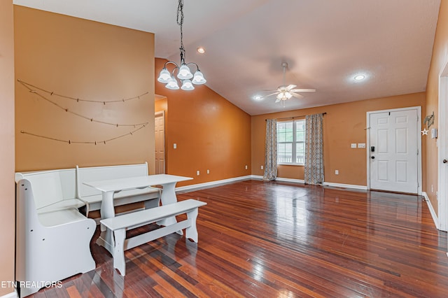 dining room featuring vaulted ceiling, dark wood-type flooring, and ceiling fan with notable chandelier