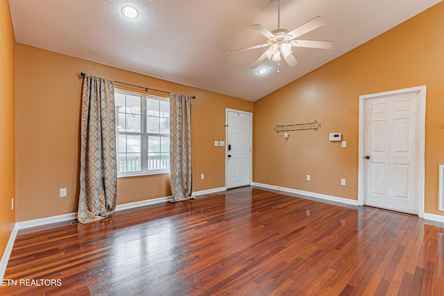 foyer featuring ceiling fan, lofted ceiling, dark hardwood / wood-style floors, and a textured ceiling