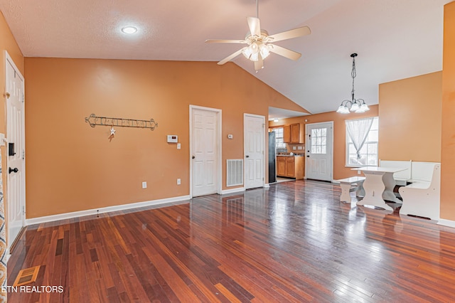 living room with high vaulted ceiling, dark hardwood / wood-style floors, and ceiling fan with notable chandelier