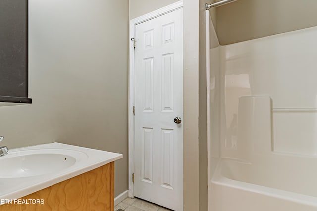 bathroom with vanity, tile patterned floors, and washtub / shower combination