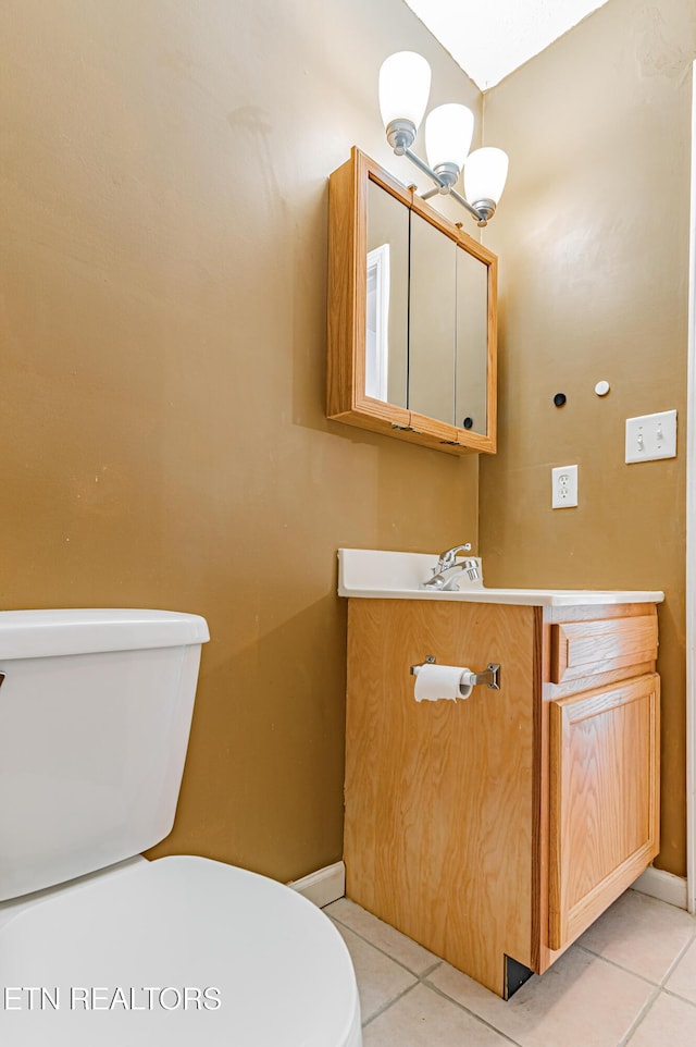 bathroom featuring vanity, tile patterned floors, and toilet