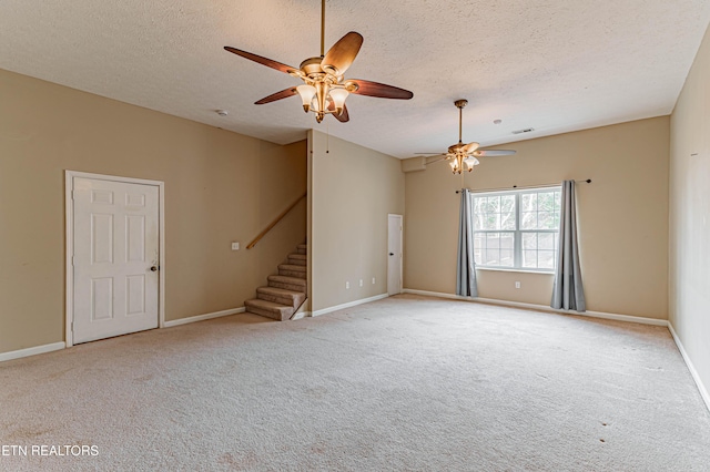 empty room with light carpet and a textured ceiling