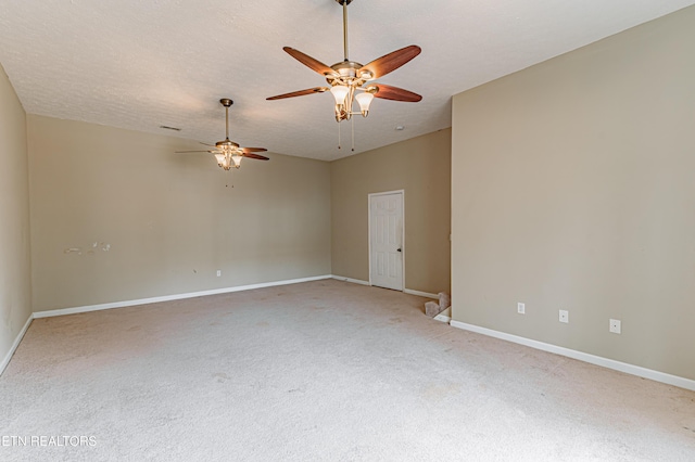 spare room with ceiling fan, carpet, and a textured ceiling