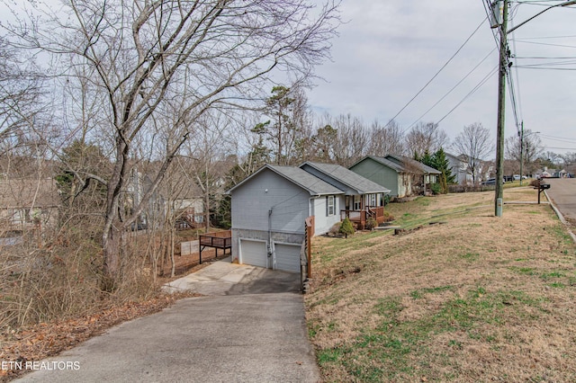 view of home's exterior with a yard and a garage