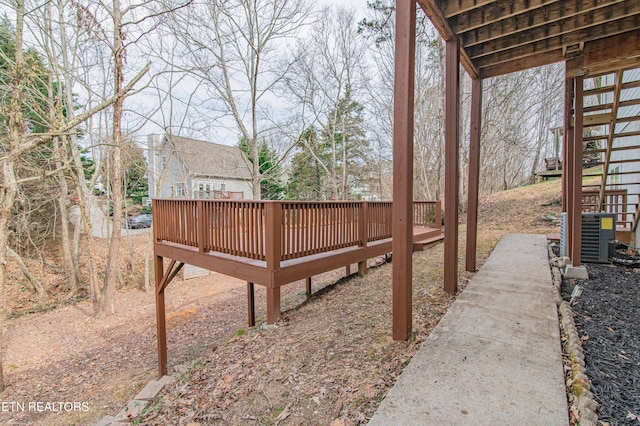 view of yard with a deck and central AC unit