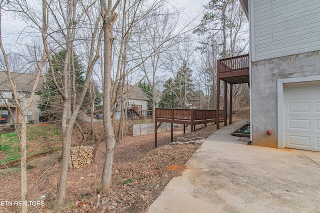 view of yard featuring a garage and a deck