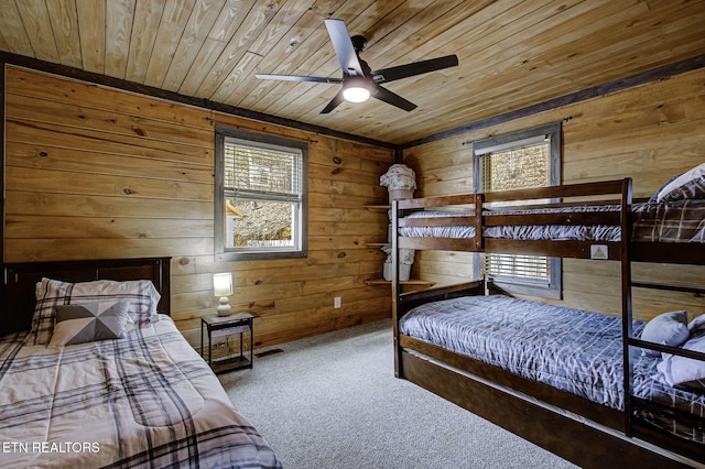 carpeted bedroom featuring wood ceiling and wood walls