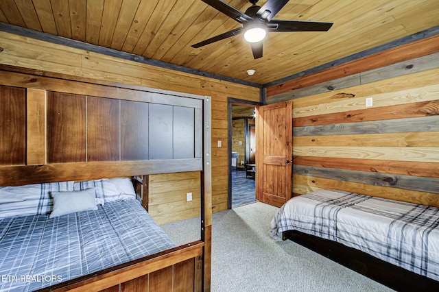 bedroom with carpet floors, wooden ceiling, ceiling fan, and wood walls