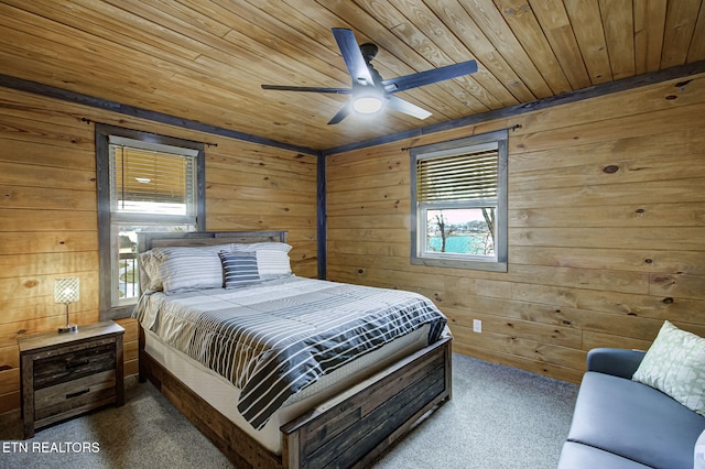 carpeted bedroom featuring wooden ceiling, ceiling fan, and wood walls